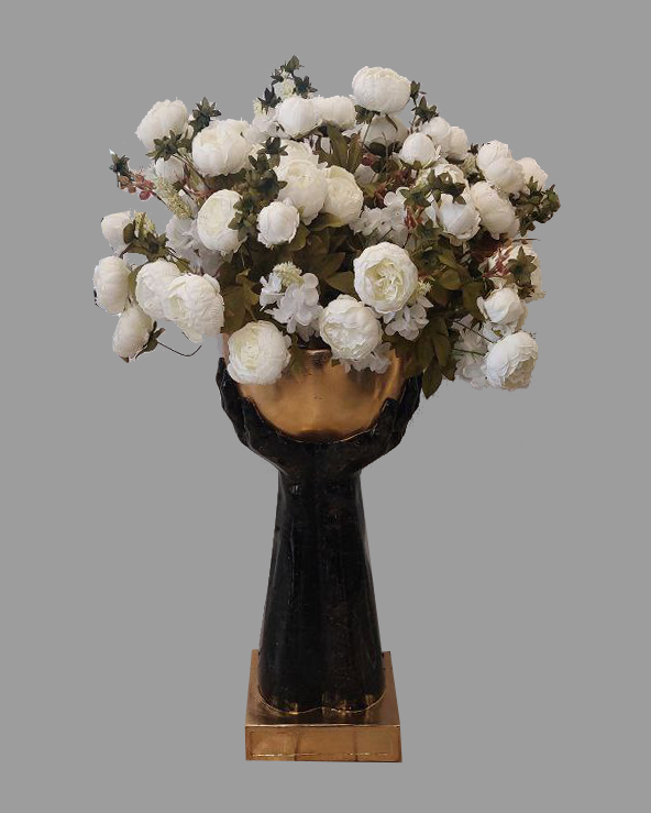Black and gold vase with hands