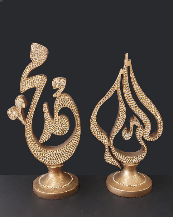 Coppia di statue color oro con strass